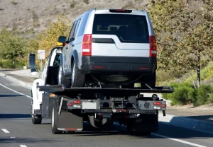 Scrap Car Removal 2 suv being towed by a tow truck